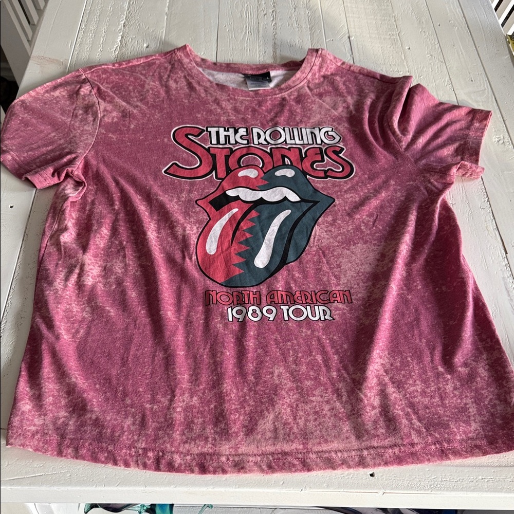 The Rolling Stones graphic tee features a bold design in a vibrant red/pinkcolor